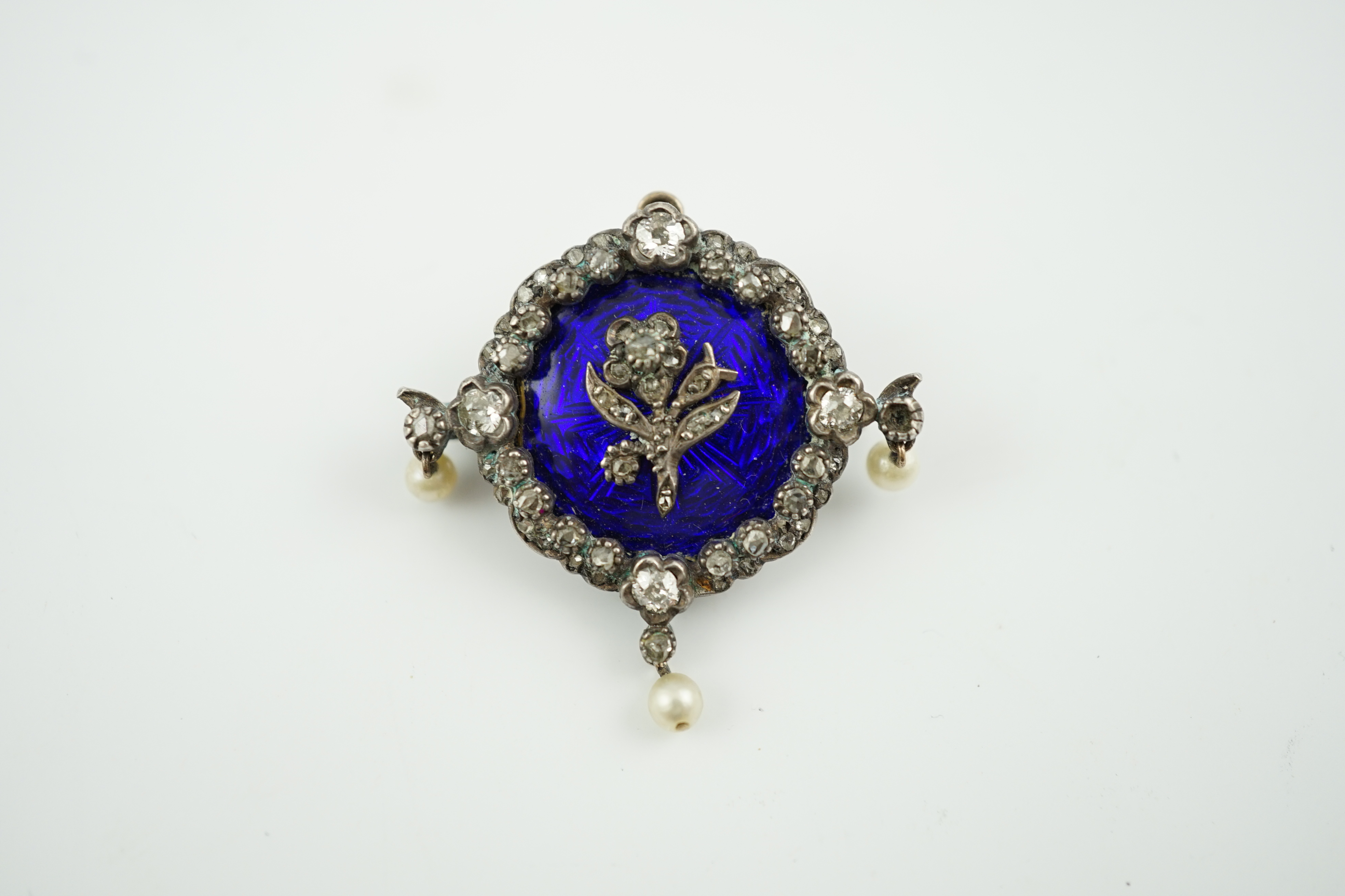 An Edwardian gold, enamel, diamond and seed pearl set drop brooch